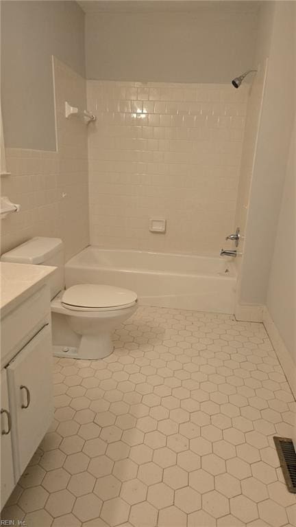 full bathroom with shower / bathtub combination, tile patterned flooring, vanity, and toilet