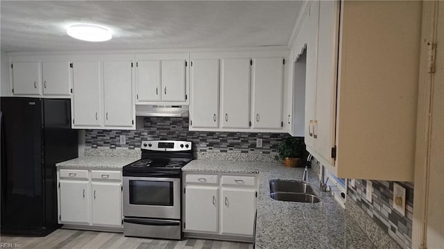 kitchen featuring black fridge, white cabinetry, and stainless steel electric range oven