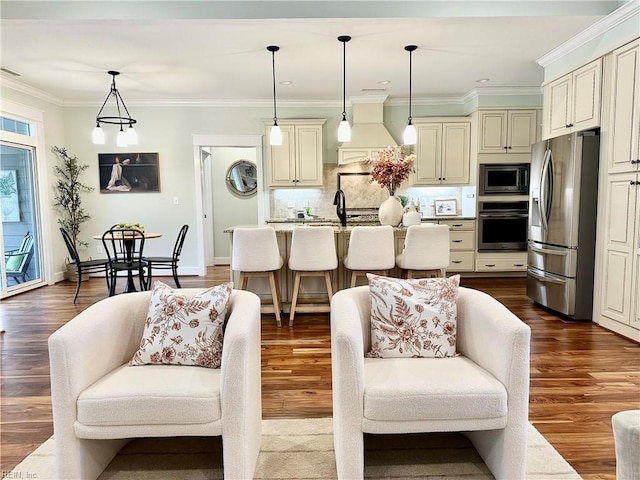 living room featuring sink, crown molding, and dark hardwood / wood-style floors