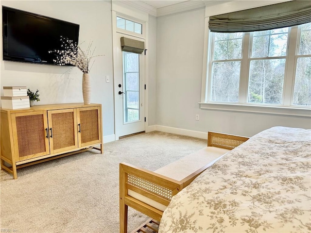 bedroom featuring access to outside, light colored carpet, crown molding, and multiple windows