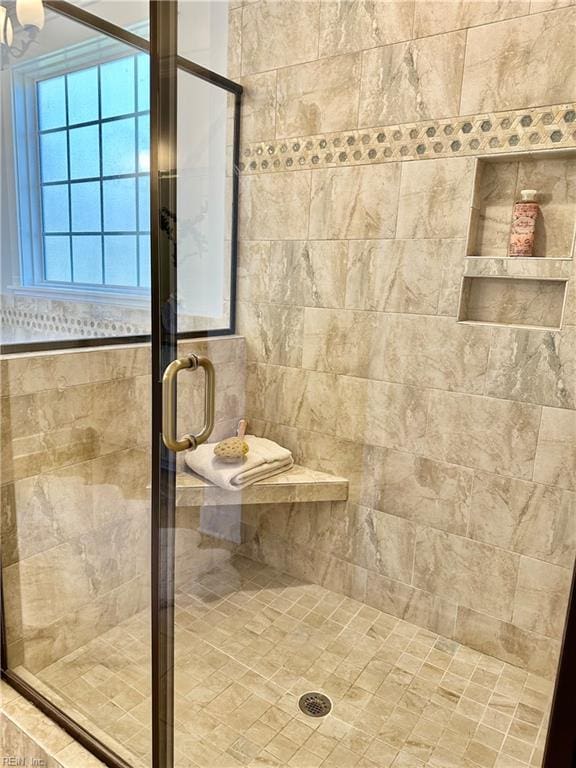 bathroom featuring a shower with door