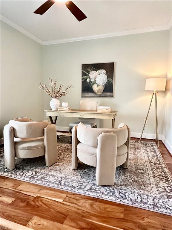 sitting room with ceiling fan, hardwood / wood-style flooring, and crown molding