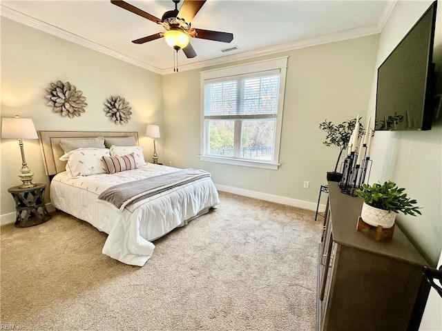 carpeted bedroom featuring ornamental molding and ceiling fan