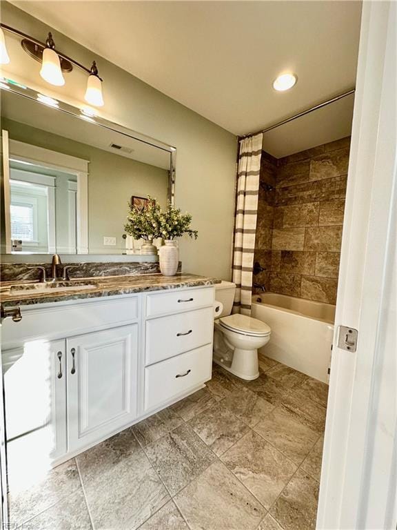 full bathroom with shower / tub combo with curtain, vanity, and toilet