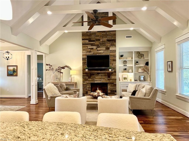 living room featuring a fireplace, ceiling fan, a healthy amount of sunlight, and built in features