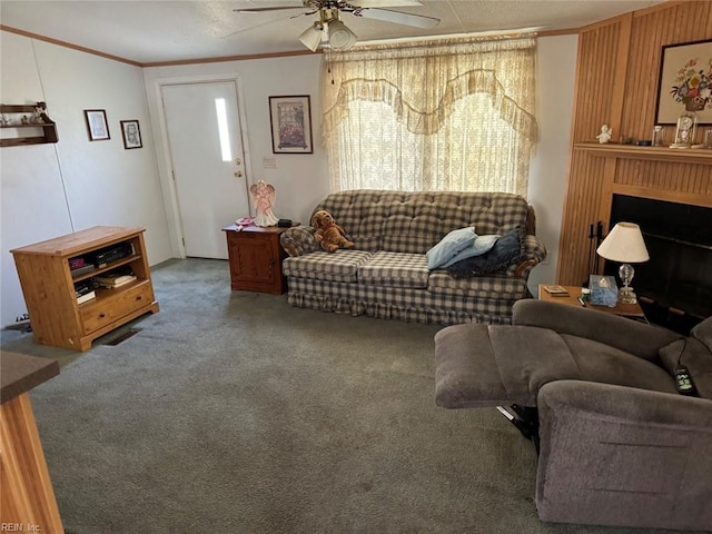 carpeted living room featuring ceiling fan and ornamental molding