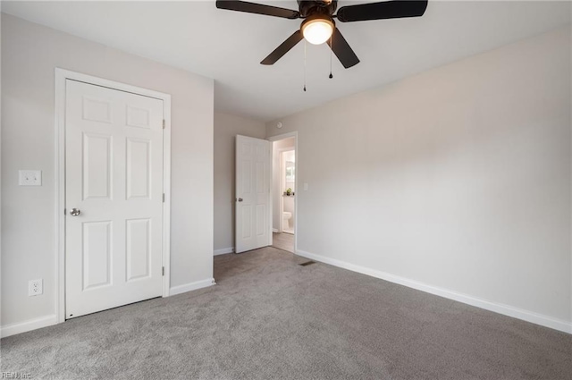 unfurnished bedroom featuring ceiling fan and light colored carpet