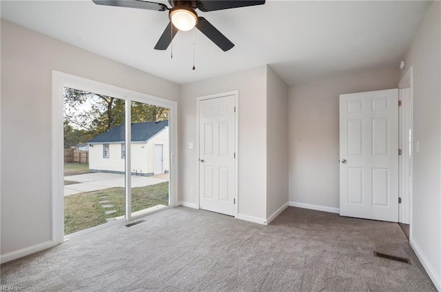 interior space featuring carpet flooring, ceiling fan, and access to outside