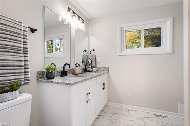 bathroom featuring toilet and vanity