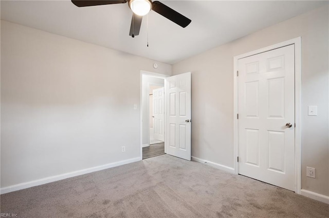 unfurnished bedroom featuring ceiling fan and light colored carpet