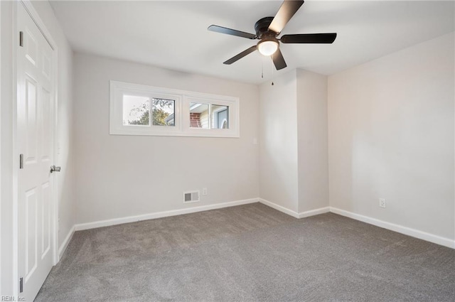 unfurnished room with light colored carpet and ceiling fan