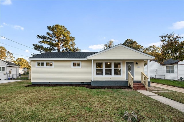 bungalow-style home with a front yard