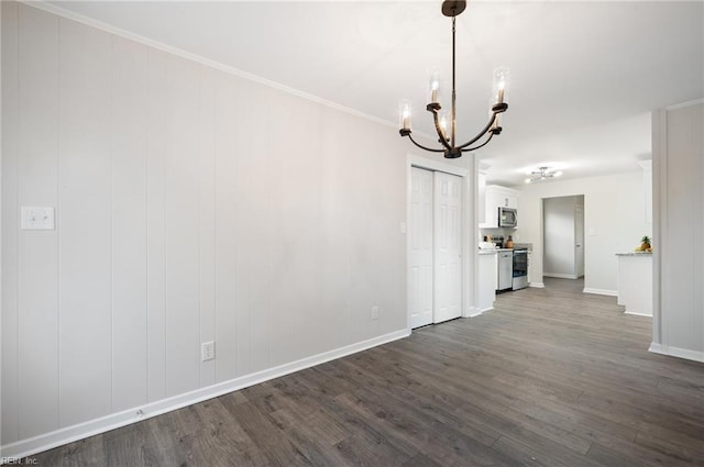 unfurnished dining area with an inviting chandelier, crown molding, and dark wood-type flooring