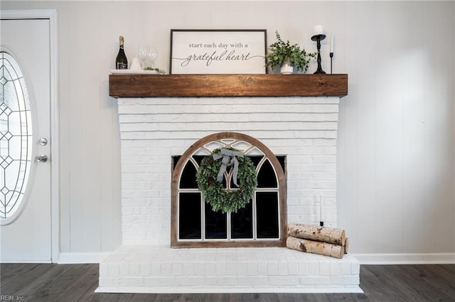 interior details featuring a fireplace and hardwood / wood-style flooring