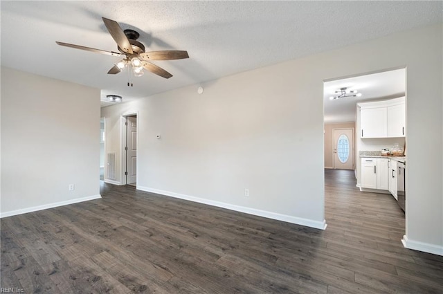 spare room featuring ceiling fan, a textured ceiling, and dark hardwood / wood-style floors