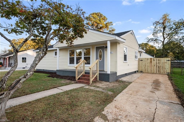 bungalow-style home featuring a front yard