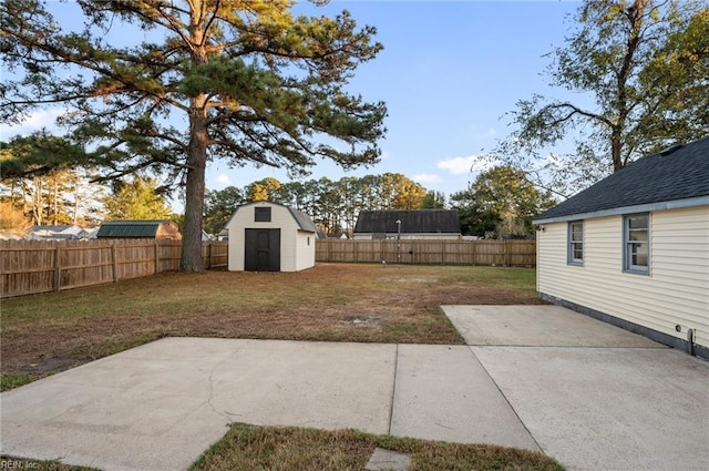 view of yard with a shed and a patio area