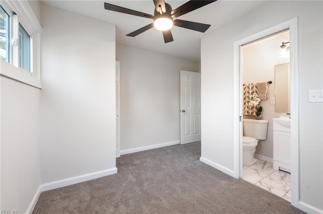 unfurnished bedroom with connected bathroom, ceiling fan, and light colored carpet