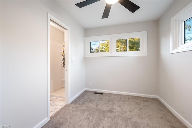 unfurnished room featuring ceiling fan and light carpet