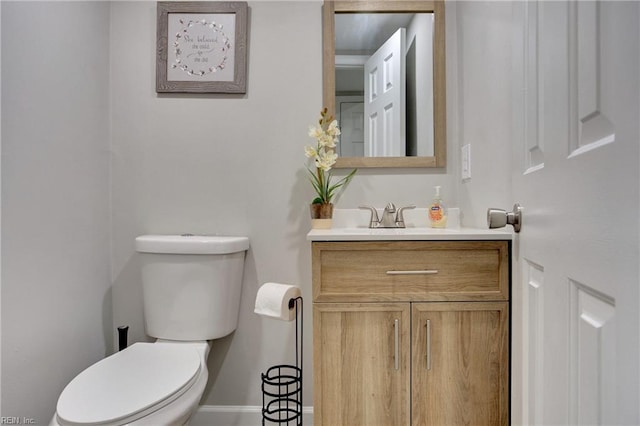 bathroom featuring toilet and vanity