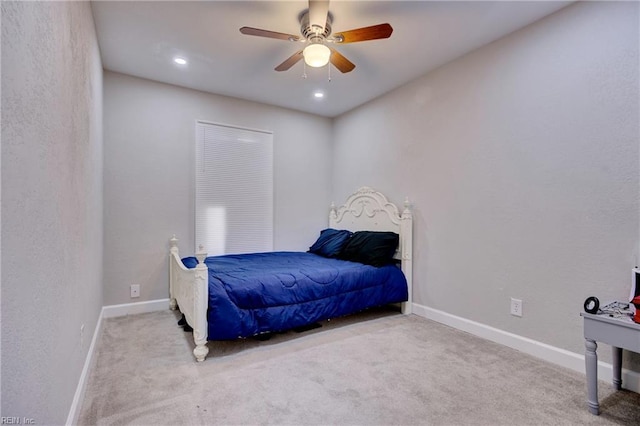 bedroom featuring ceiling fan and light colored carpet