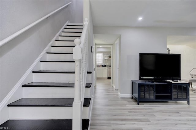 staircase with hardwood / wood-style floors