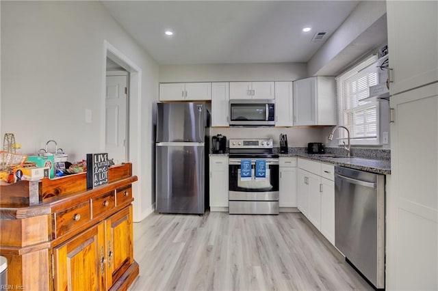 kitchen featuring light hardwood / wood-style floors, sink, white cabinetry, and appliances with stainless steel finishes