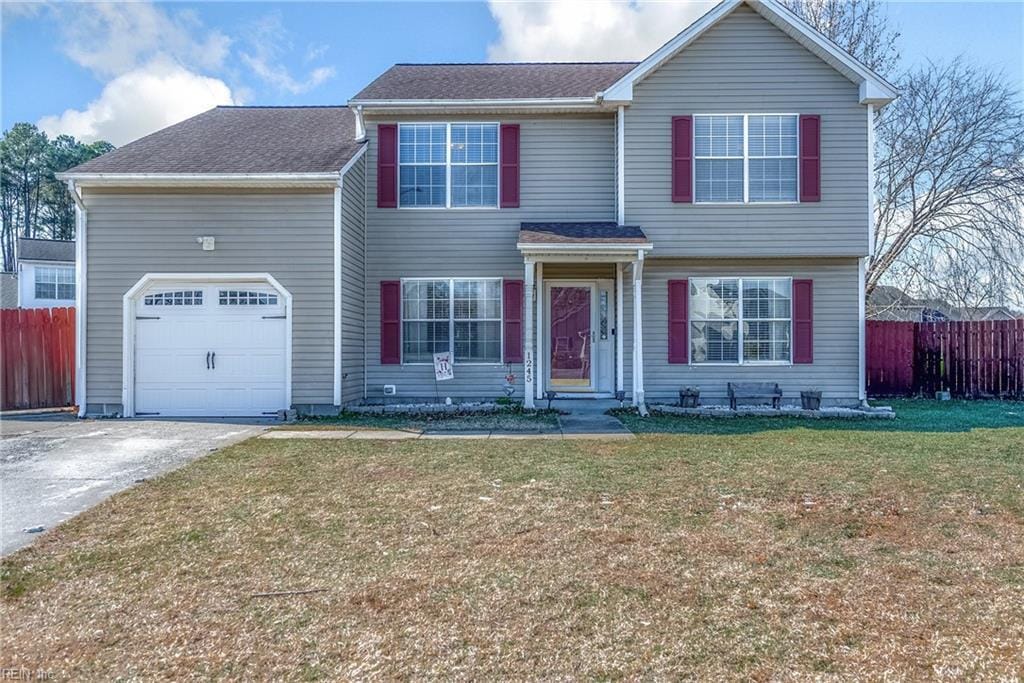 view of front of property featuring a garage and a front yard