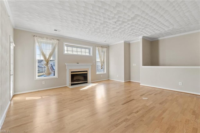 unfurnished living room featuring a textured ceiling, light wood-type flooring, and crown molding