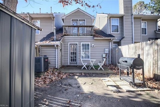 back of property with a patio area, central AC, and a balcony