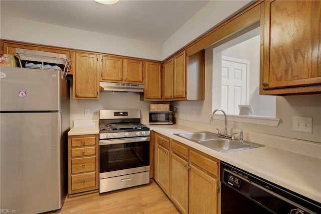 kitchen with light hardwood / wood-style floors, sink, and appliances with stainless steel finishes