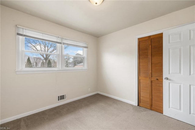 unfurnished bedroom with carpet and a closet