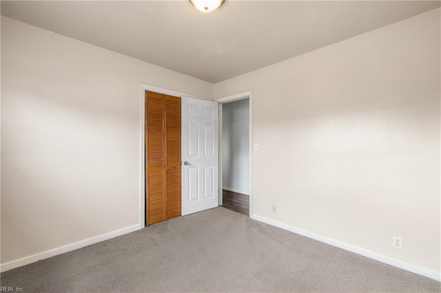 unfurnished bedroom featuring a closet and carpet