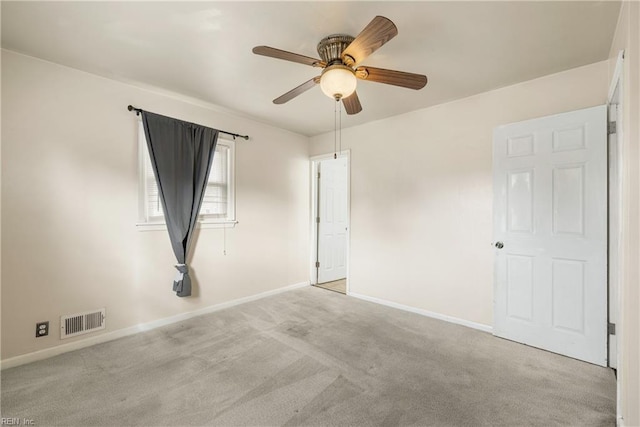 carpeted spare room with ceiling fan