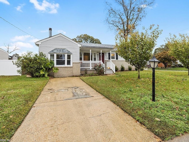 view of front of house with a front yard and a porch