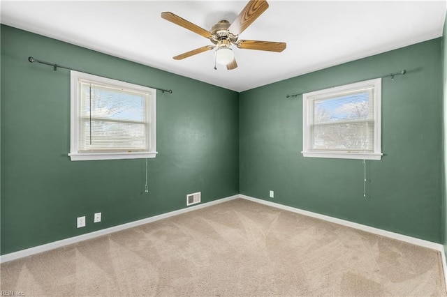 carpeted spare room with ceiling fan