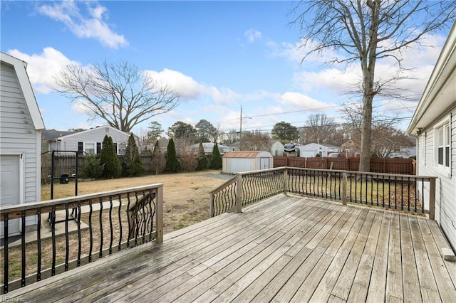 deck featuring a shed and a lawn