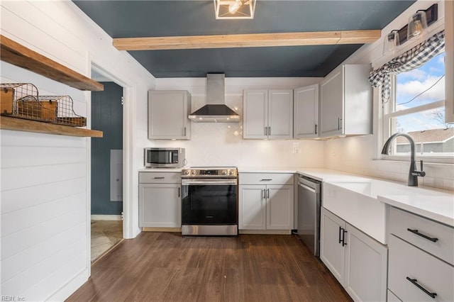 kitchen with tasteful backsplash, dark hardwood / wood-style floors, wall chimney range hood, and stainless steel appliances