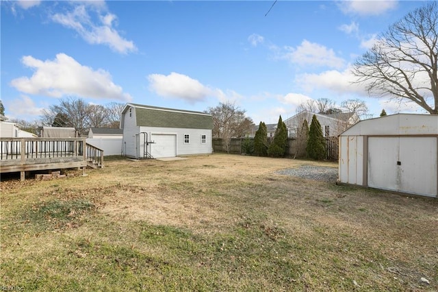 view of yard with a deck and a storage unit