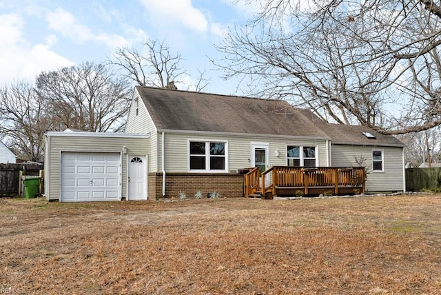 view of front facade featuring a garage, a deck, and a front lawn