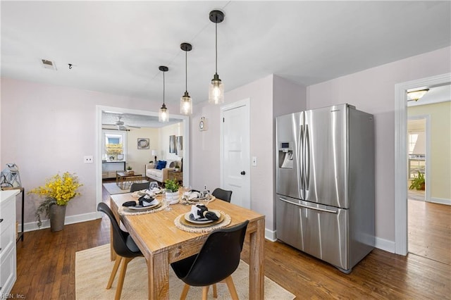 dining area featuring ceiling fan, plenty of natural light, and dark hardwood / wood-style floors