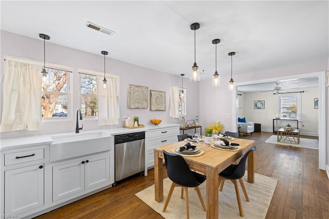 kitchen with white cabinetry, ceiling fan, pendant lighting, stainless steel dishwasher, and sink