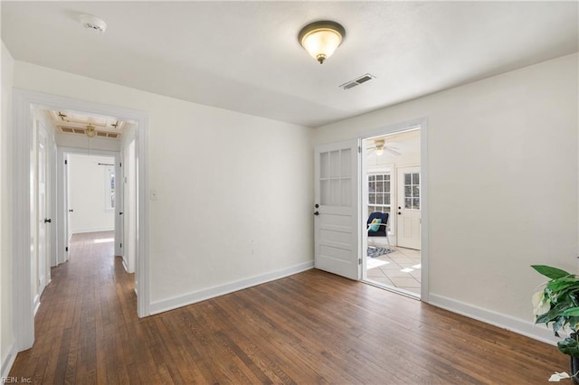 unfurnished room with french doors and dark wood-type flooring