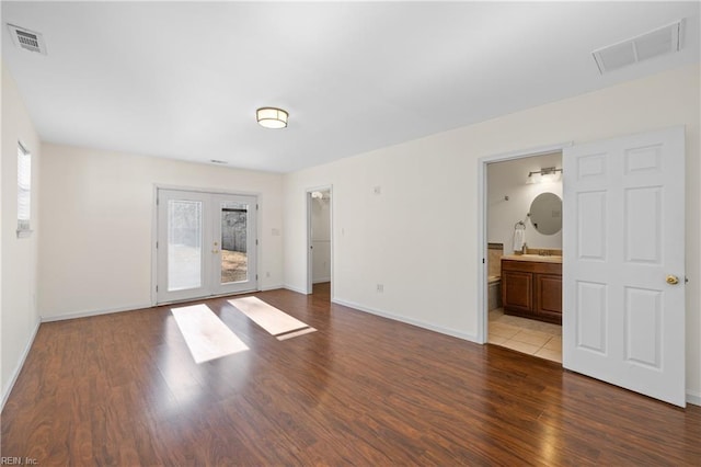 empty room featuring light wood-type flooring and french doors