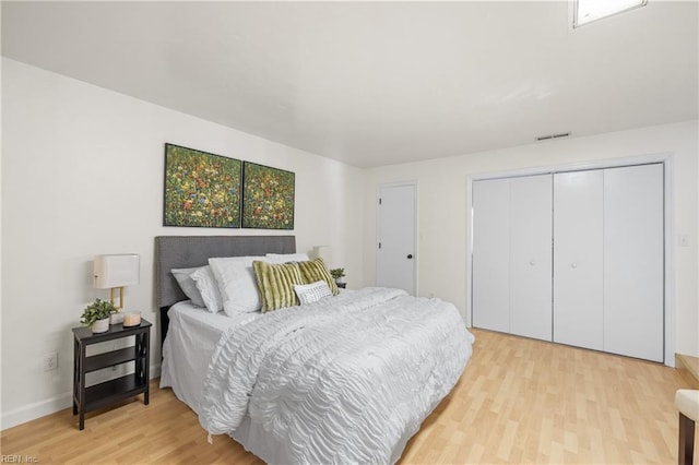 bedroom with a closet and light wood-type flooring