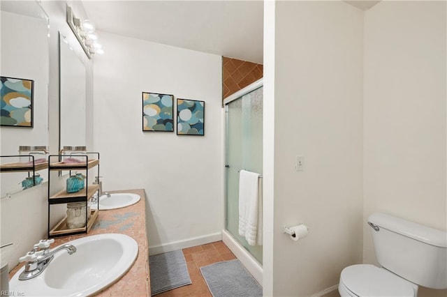 bathroom featuring an enclosed shower, vanity, tile patterned floors, and toilet