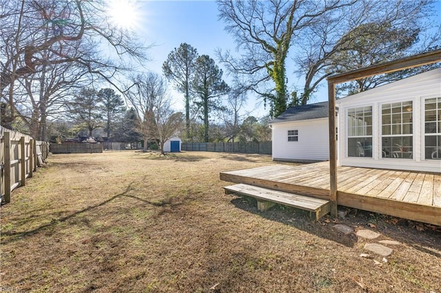 view of yard with a storage unit and a wooden deck