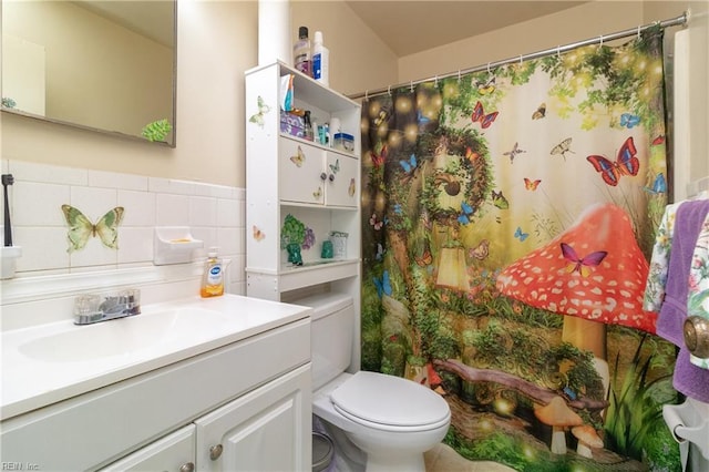 bathroom featuring toilet, vanity, tile walls, and curtained shower