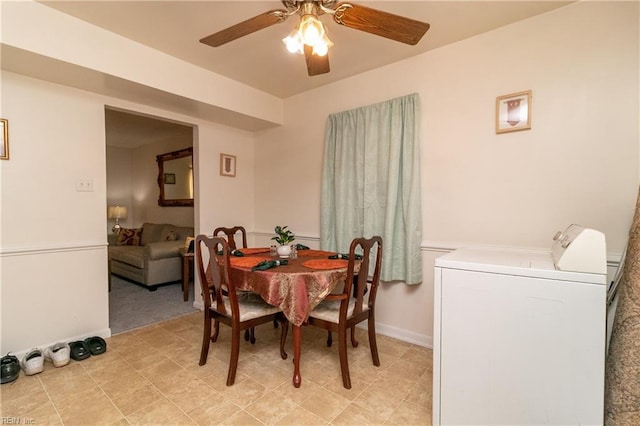 dining room featuring ceiling fan and washer and dryer