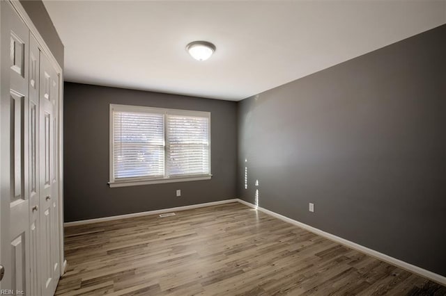 unfurnished room featuring hardwood / wood-style floors